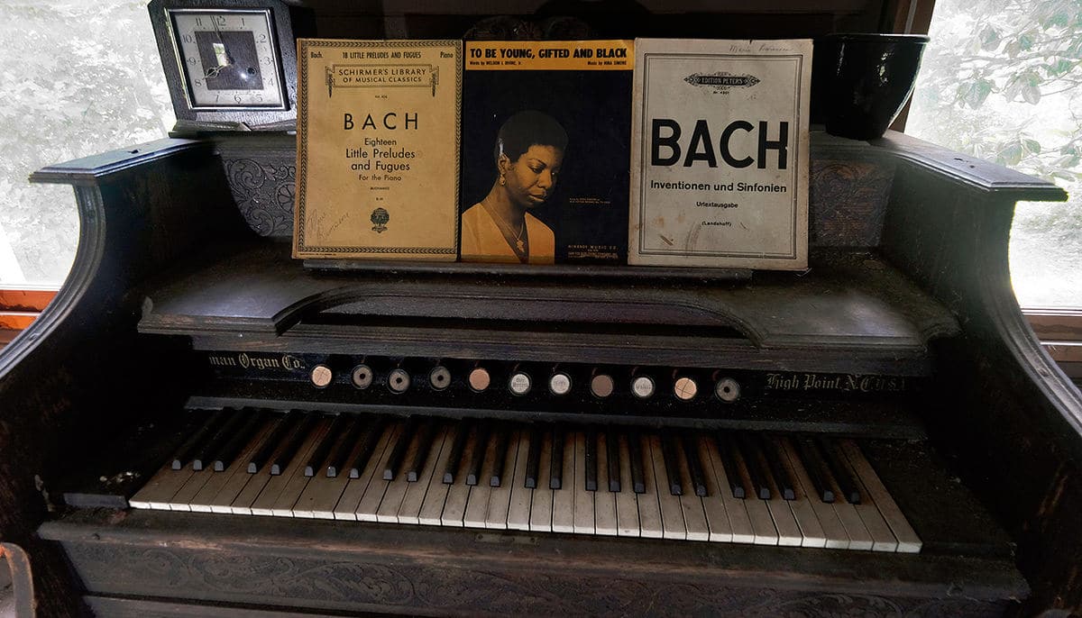 Simone's sheet music and period-style piano remain from previous efforts to use the house as museum 